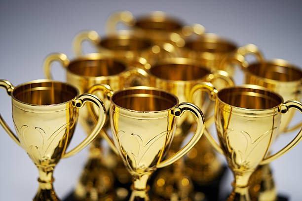 group of gold trophies on white background
