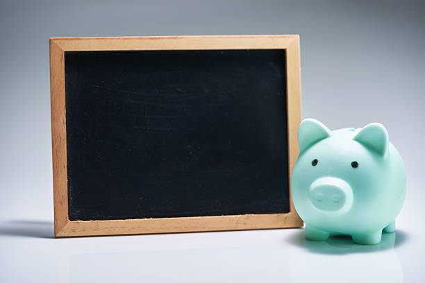 piggybank and small chalkboard against white background
