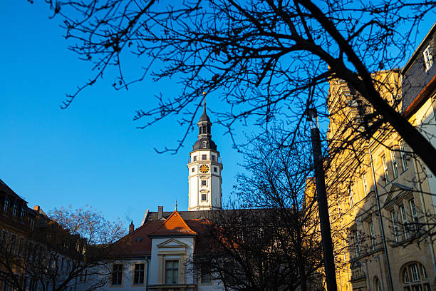 Leipzig, Germany, May 1, 2024 - Tourists and locals stroll along the market with the old town hall downtown Leipzig.