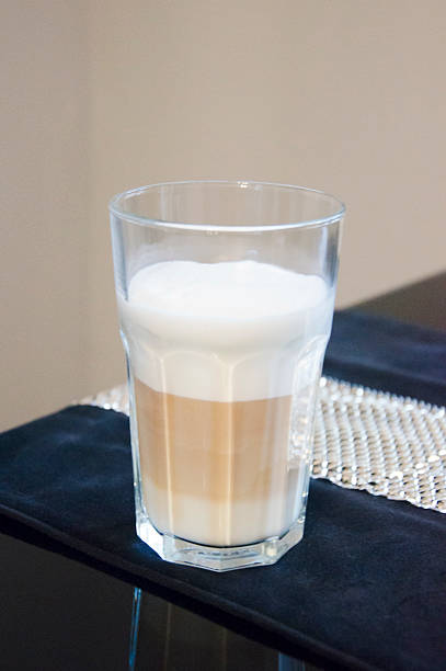 Latte macchiato in clear glass with milk foam
