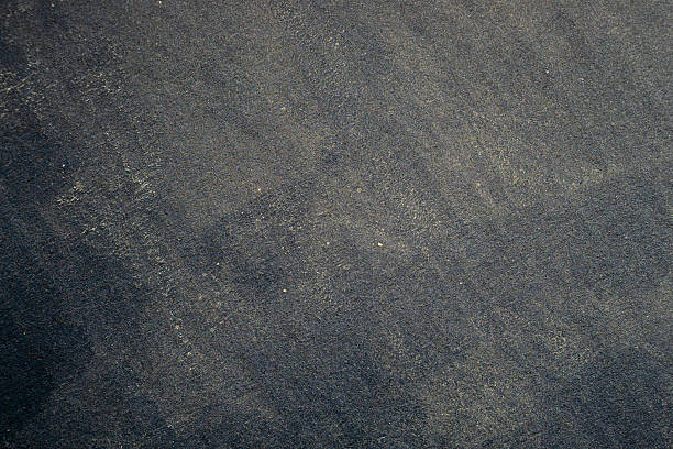 istock Smooth dark cardboard surface with visible dust and fine particle details 2259561439