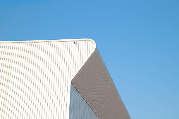 istock Factory industry, Architecture Building with Aluminium Facade on Blue Sky Background, Backdrop Wall Metal Corrugated Steel Surface Pattern, Warehouse Construction in Geometric Modern Design 2259562358