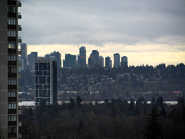 Cityscape with high-rise buildings on overcast sky background in Surrey, BC
