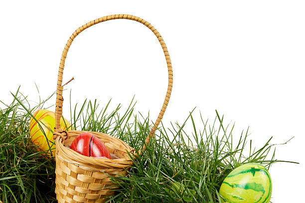 Easter painted eggs in a green basket on a green background. Easter Composition. High quality photo