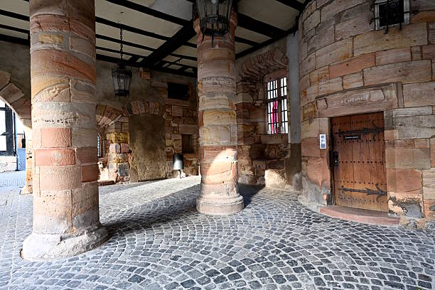 A view of the cobblestone path that leads to the main gate of Orava Castle, one of Slovakia’s most iconic medieval fortresses. This picturesque pathway, set against the backdrop of stone walls and towers, guides visitors toward the main courtyard of the castle. Located in Oravský Podzámok, the castle is renowned for its blend of Gothic, Renaissance, and Baroque architectural styles. The cobblestone path is a striking example of the medieval design that once protected and connected the various sections of the castle.