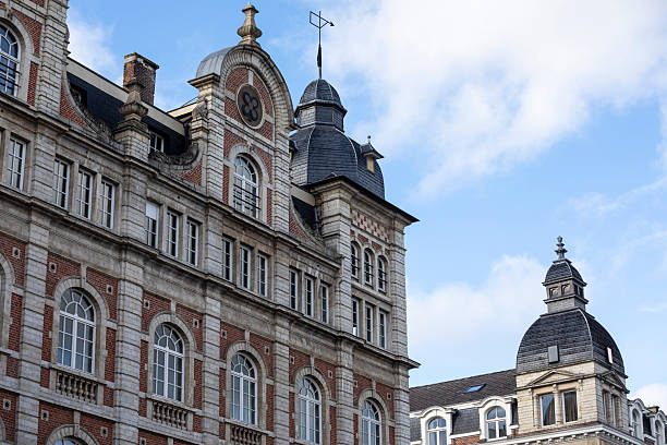 A stunning view of the ornate stone façade of Aachen's City Hall, adorned with sculptures and intricate architectural details, symbolizing the city's rich history