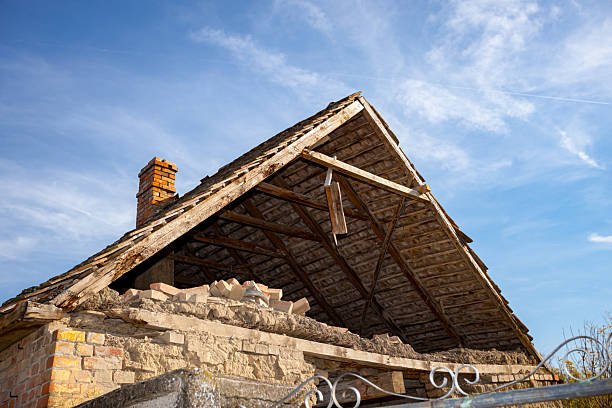 Abandoned neglected old adobe house made with bricks of mud, clay and straw with hole in wall.