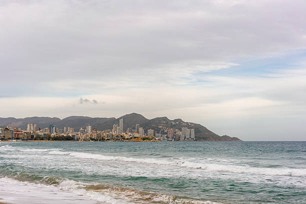 Benidorm beach with hotels on a cloudy day, in Spain