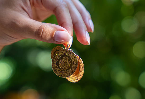 Young woman holding Turkish Gold coins in hand
