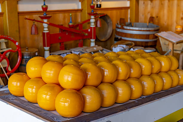 Yellow Edam cheese wheels displayed on a market stall in Edam, Netherlands