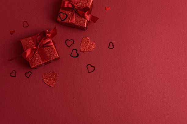 istock Red Glitter Gift Boxes and Hearts on Festive Background for Valentines Day Celebration 2259621367