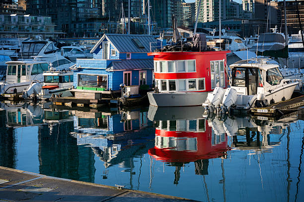 House Boats reflecting in the calm water of Coal Harbor in downtown Vancouver. British Columbia, Canada. January 16, 2026.