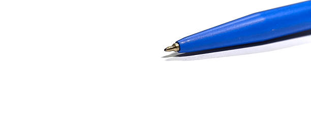 A red ballpoint pen on a white table.