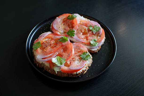Open Sandwich With Tomato Slices and Cream Cheese on Plate