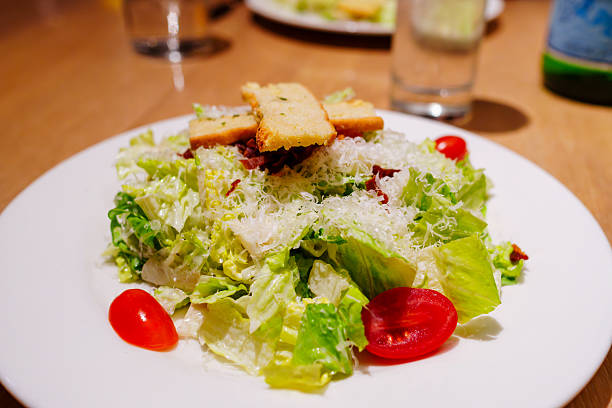 Bacon, lettuce and tomato with mayo smear on two white plates
