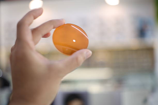 Hand a doctor holding sunglasses lens in optical, optical lens industry