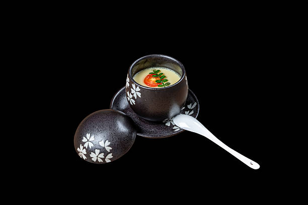 Chinese cuisine on a plate against a black background