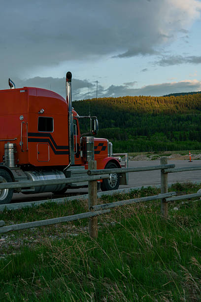 Truck on the highway surrounded by forest in Canada