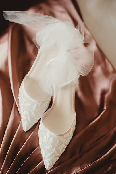Bride's white high heel shoes with tulle laces