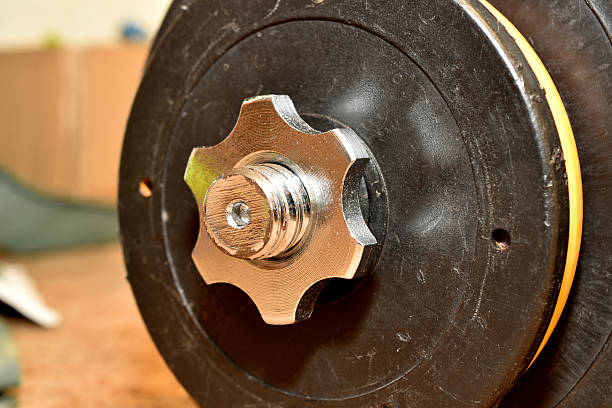Attaching a collapsible dumbbell with a nut. Close-up of the attachment.