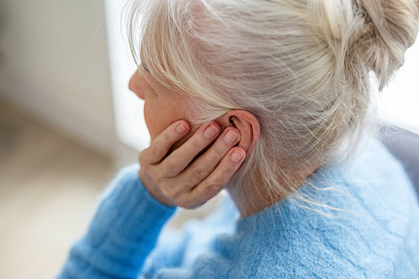 istock Senior woman suffering from earache 2259699786