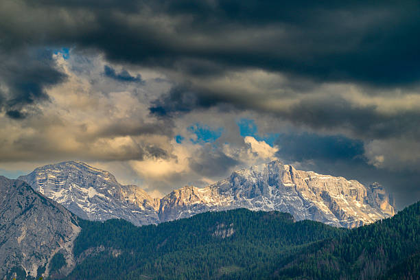 Clouds over the mountain peaks in the Dolomites Italy during a beautiful springtime sunset near Cortina D'Ampezzo.