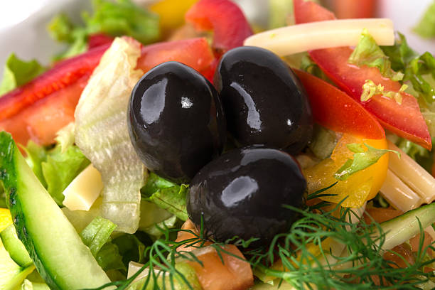 Fresh vegetable salad with olives. Macro. Photo can be used as a whole background.