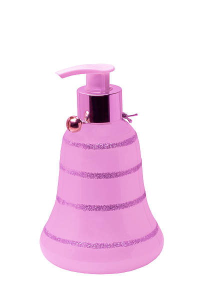 Pink glass bottle dispender with liquid soap isolated on white background. Clipping path. Shampoo bottle for bathroom. Skin care lotion.