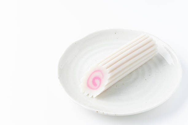 Single Japanese Naruto Fish Cake on a Plate on White Background