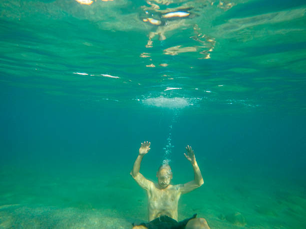 Underwater portrait of a middle aged man swimming during summer vacation