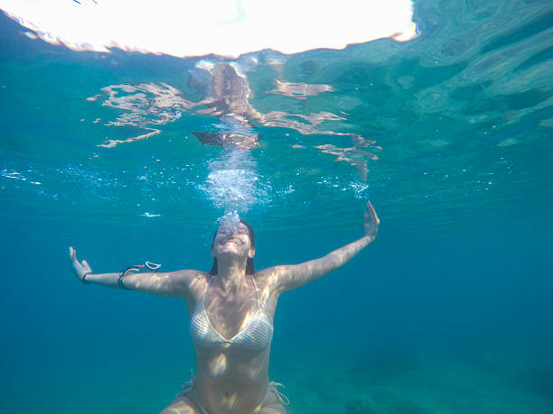 Underwater portrait of a young woman snorkeling during summer vacation