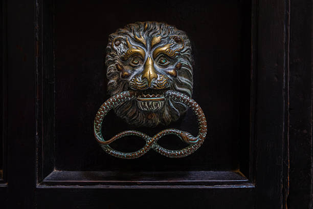 Granada, Spain, Andalusia - March 28, 2025: Decorative metal knocker on facade of Palace of Charles V, renaissance building inside fortress Alhambra, former Nasrid palace complex