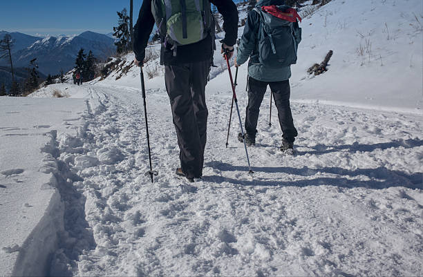 In late June this year, there is still a lot of snow on the trail leading to the lake called La Vecchia, the thaw being late.  A young woman in a hat climbs up the snowdrift. The lake is located on the border between Piedmont, Cervo Valley, and Aosta Valley, Lys Valley. The mountain range embracing the lake appears majestic, steep, and mighty.