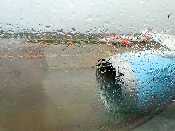 Rain drops on window of airplane before take off
