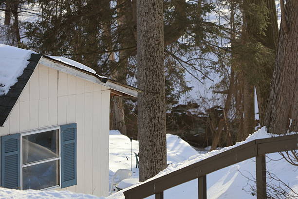 A rural house covered in snow in the winter