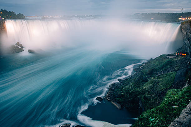 Long exposure view of Niagara Falls creating soft motion blur in flowing water. The image emphasizes movement, energy and the raw force of nature in a famous Canadian landscape.