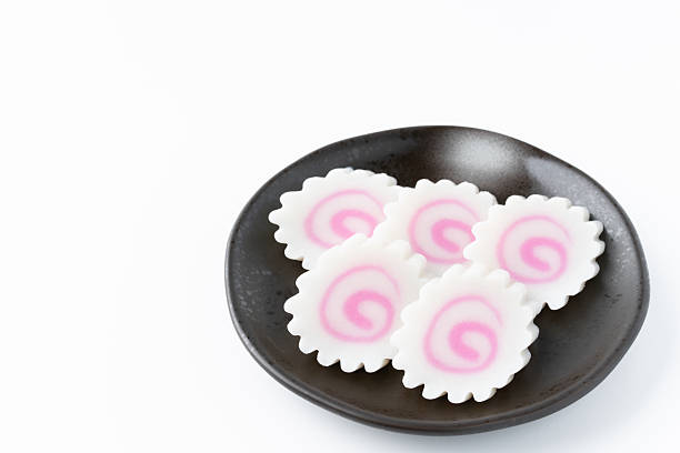 Sliced Japanese Naruto Fish Cake on a Plate on White Background