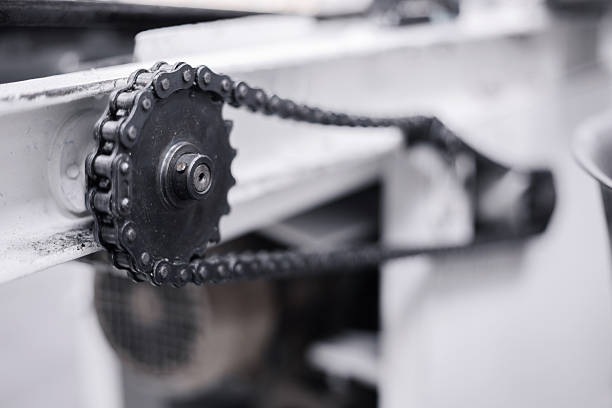 Industrial chain and sprocket mechanism from a factory machine showing power transmission