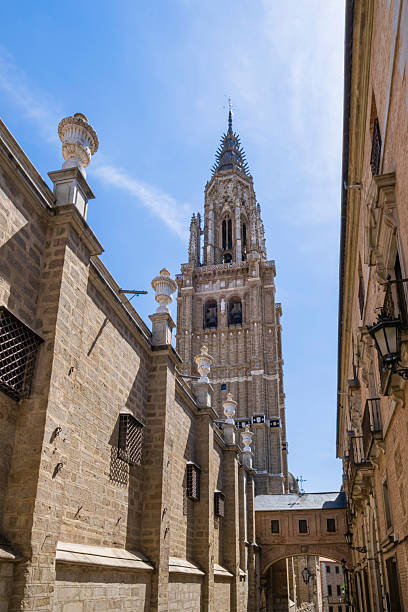 Traditional architecture in the old town of Toledo: in background, the imposing tower of the Cathedral of Saint Mary of the Assumption