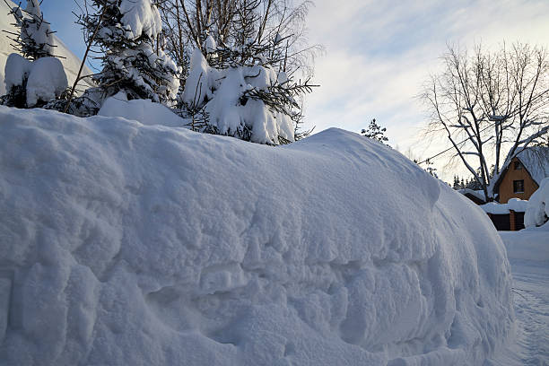 Close-up view of melting dirty snow forming rough winter textures and layered ice surfaces. This natural outdoor detail is suitable for use in environmental topics, weather reports, urban winter scenes, seasonal backgrounds, and articles about road maintenance, climate, and winter safety.