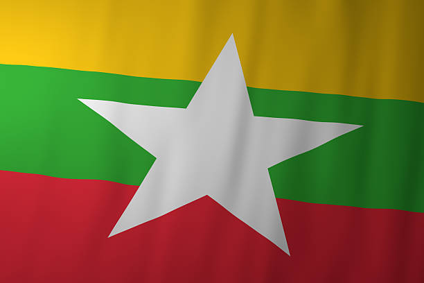 The national flag of Myanmar displaying horizontal yellow, green, and red stripes with a prominent white star at the center. The flag symbolizes unity, independence, and national identity.