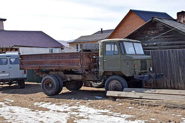 camouflage jacket draped over the fender of an old military off-road vehicle.