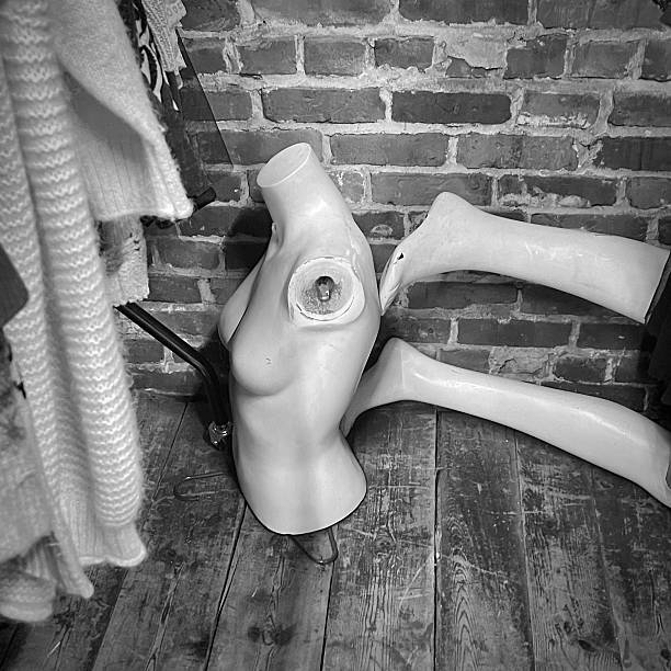 Vintage clothing in a thrift shop with mannequin parts. abstract still life concept. no people