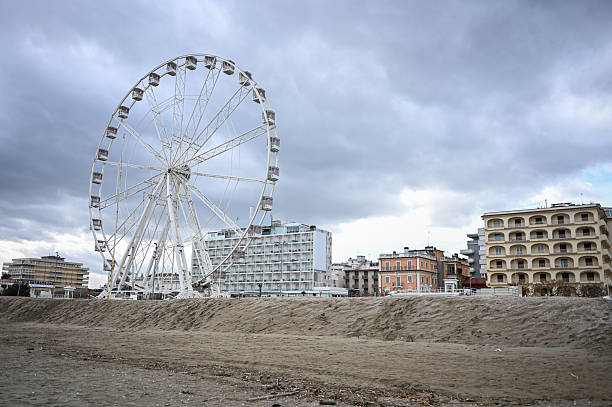 Ferris wheel framing the Rimini skyline and Adriatic coast on a cloudy day