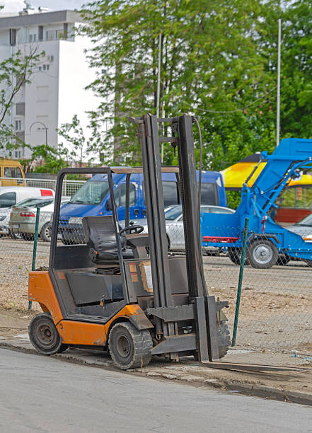 Small Orange Forklift Tuck Vehicle at Outdoor Parking