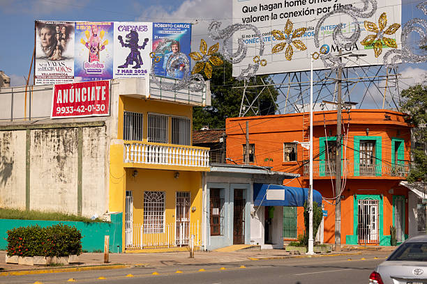 Villahermosa, Tabasco, Mexico - January 2, 2026: Afternoon traffic passes by colroful homes in downtown.