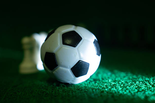 Creative soccer concept with ball and symbolic team figures representing teamwork, competition, leadership, sports strategy and collective effort. Ideal for sports, business teamwork and motivation themes.