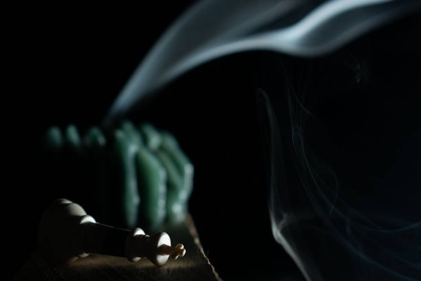 Moody conceptual image of a burning candle with smoke and clock symbolizing time passing, fragility, memory, urgency, reflection and the end of a cycle. Ideal for emotional, philosophical and mental health concepts.