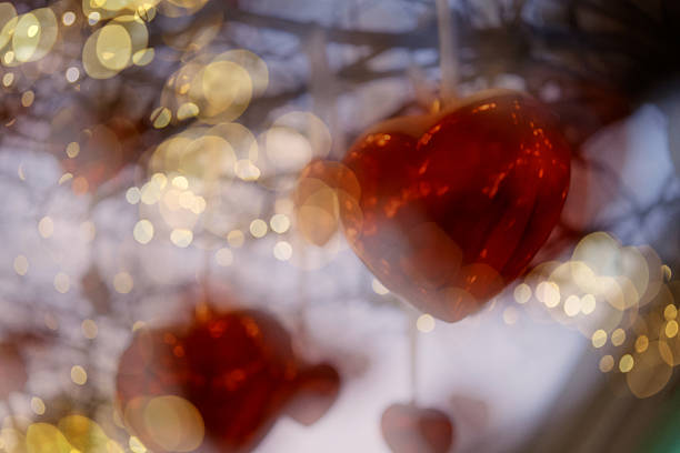 Romantic festive background featuring glowing glass hearts surrounded by soft lights and bokeh. Transparent hearts reflect warm illumination, creating a dreamy and emotional Valentine’s Day atmosphere. This background is ideal for romantic designs, greeting cards, wedding visuals, invitations, love-themed advertising, and holiday promotions. Suitable for digital and print projects, photo and video overlays, and creative compositions.