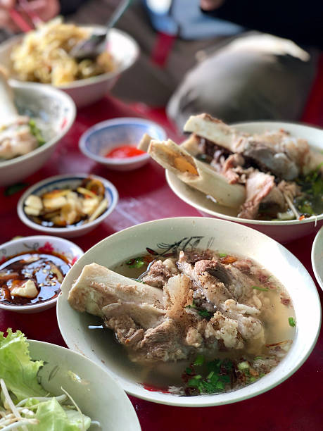 Close-up of Vietnamese hu tieu xi quach breakfast noodle soup at local eatery.